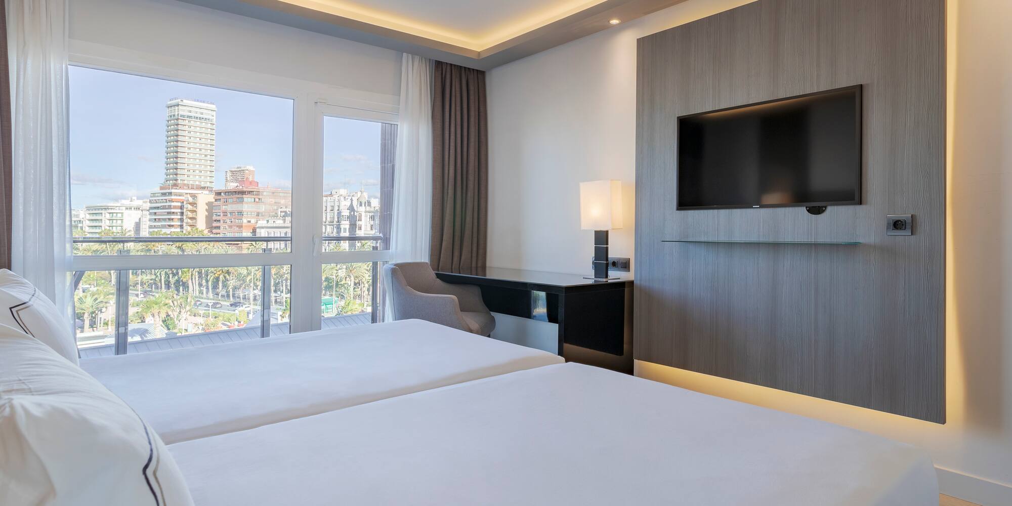 a room with a television and a couple of beds