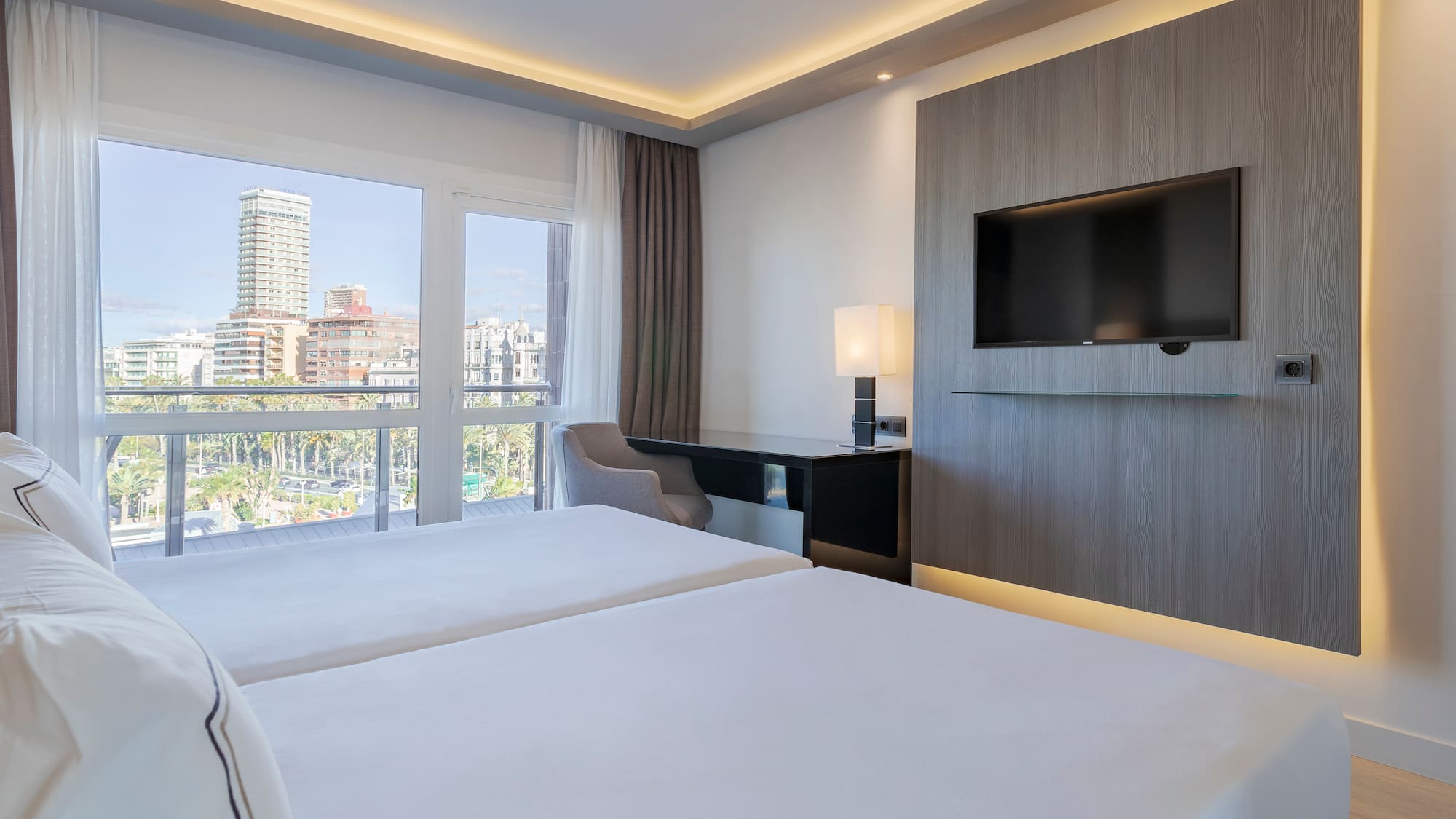 a room with a television and a couple of beds