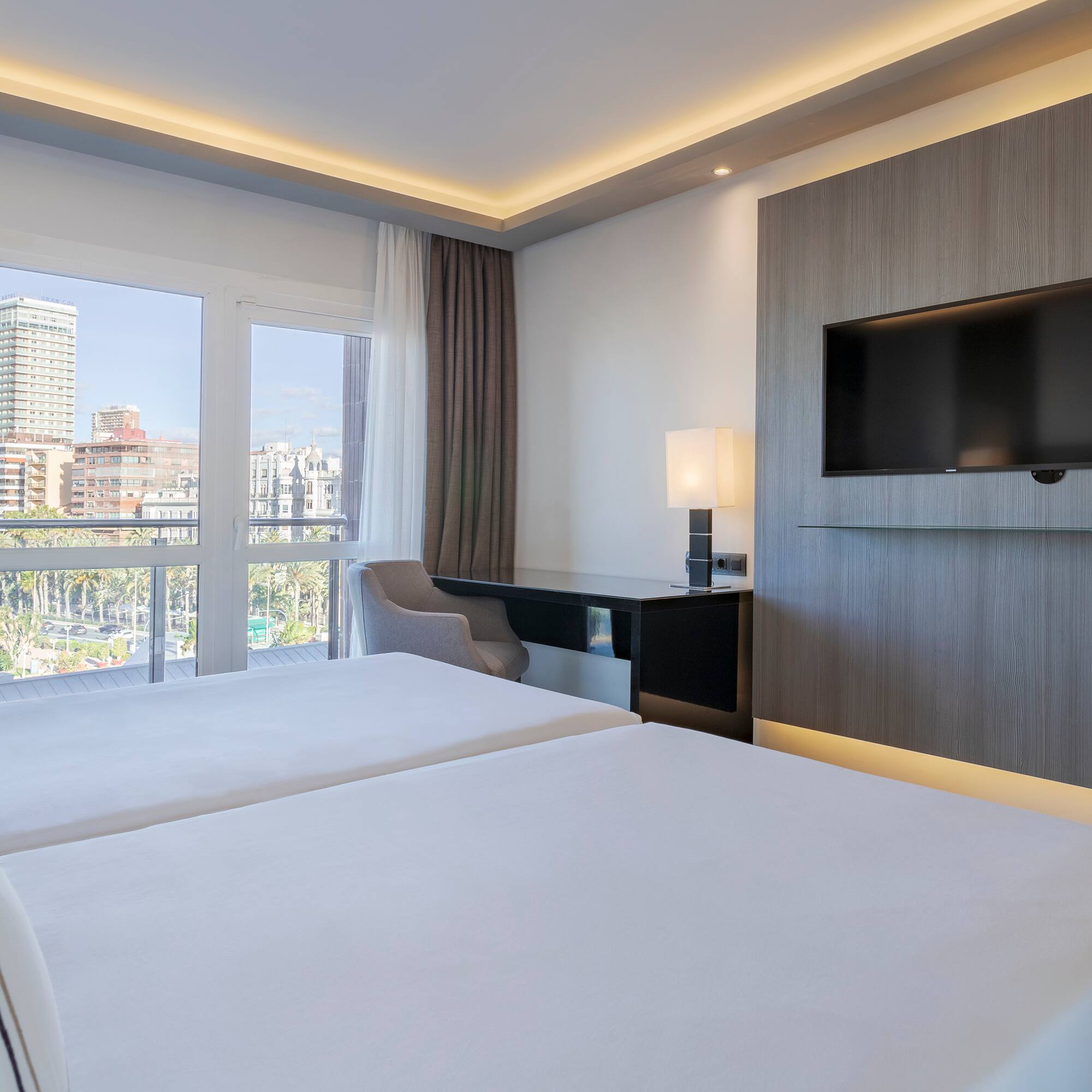 a room with a television and a couple of beds