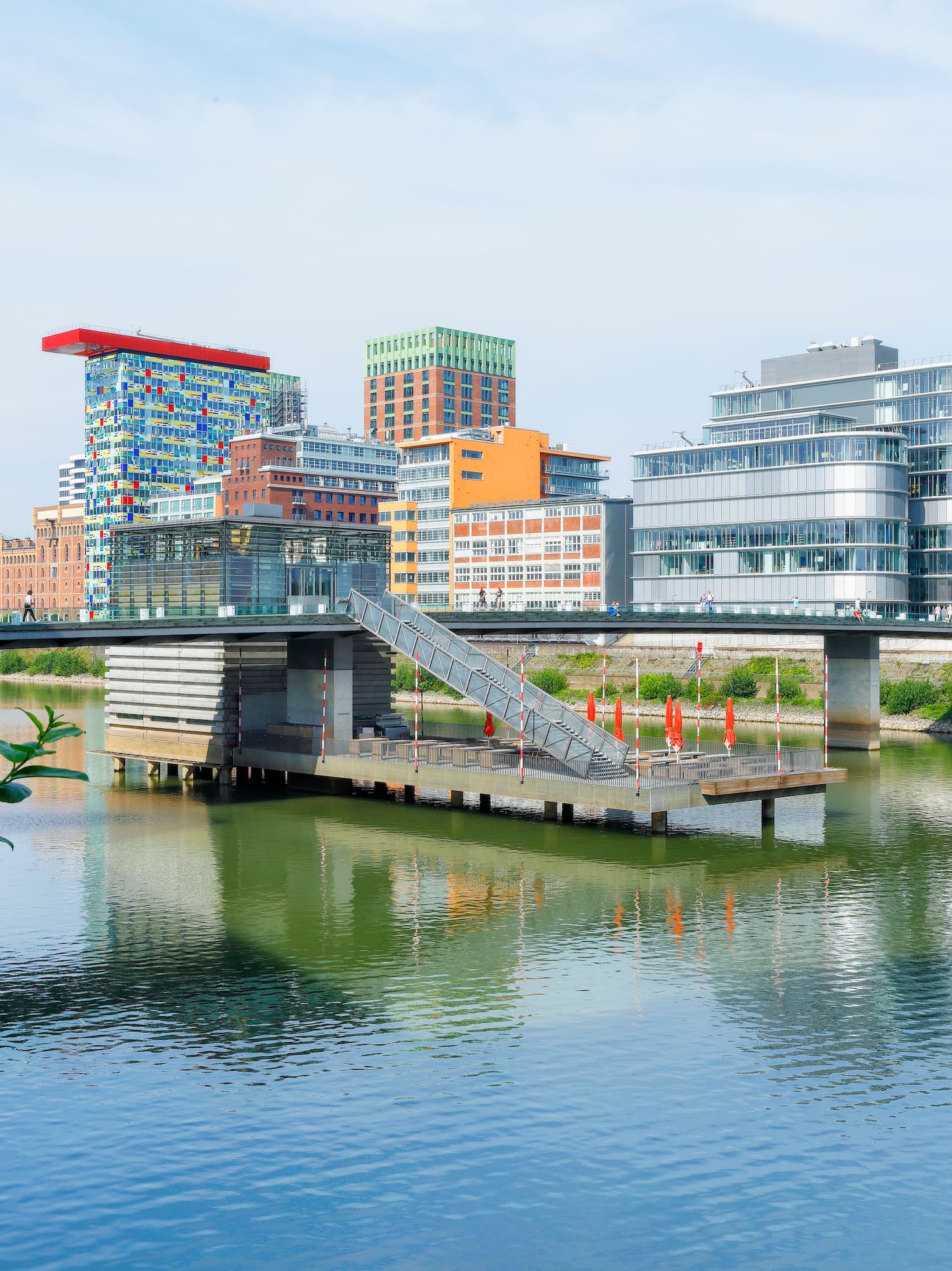 a bridge over a body of water with a city in the background