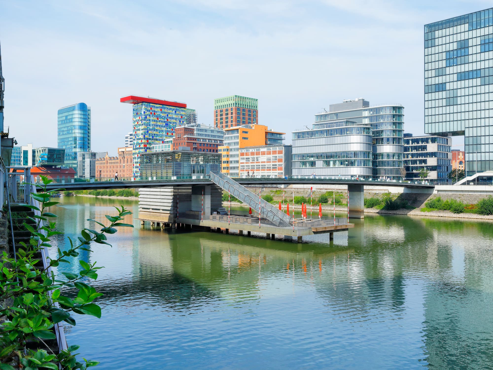 a bridge over a body of water with a city in the background