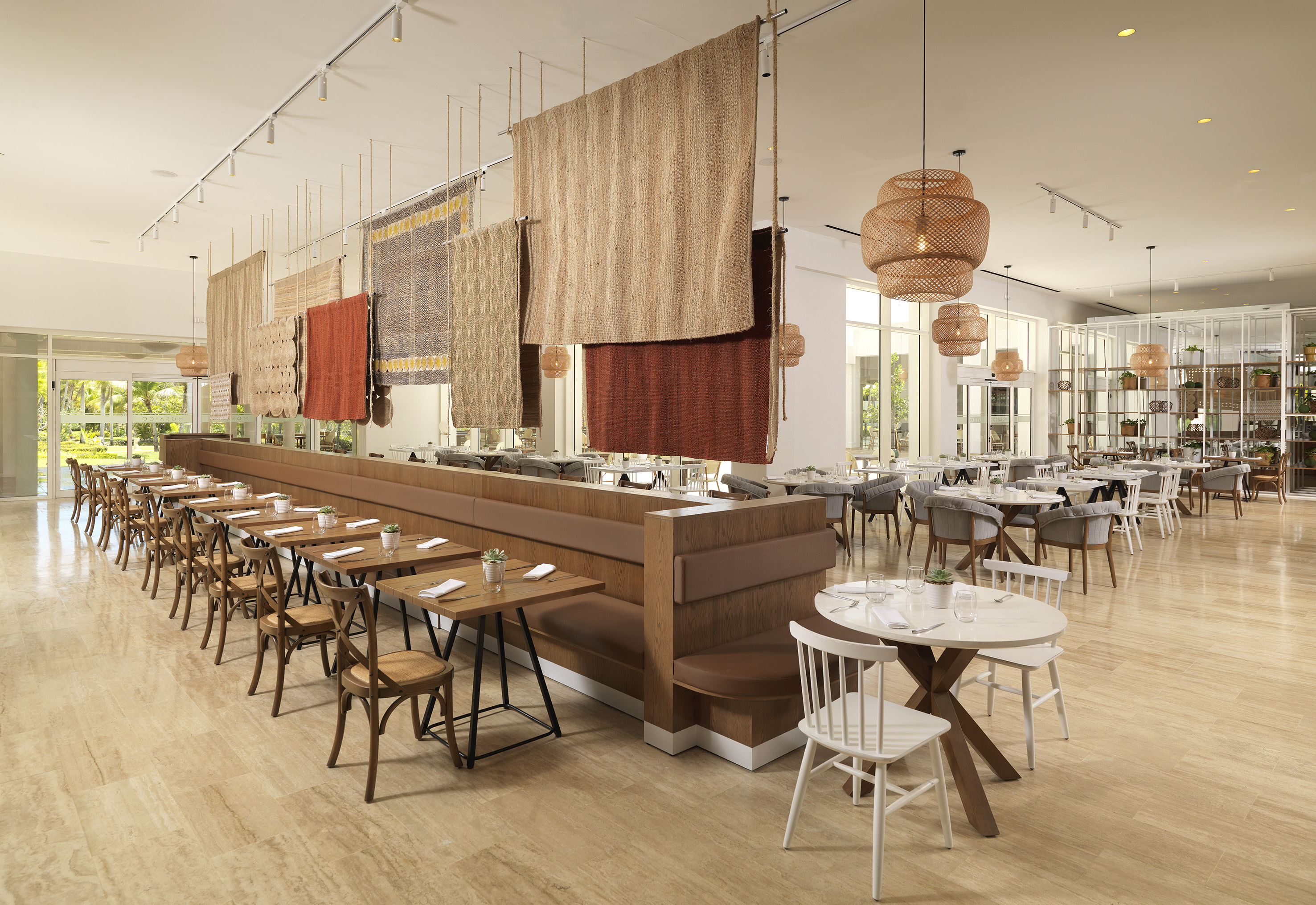 Modern restaurant with woven partitions, ample seating, and natural light.