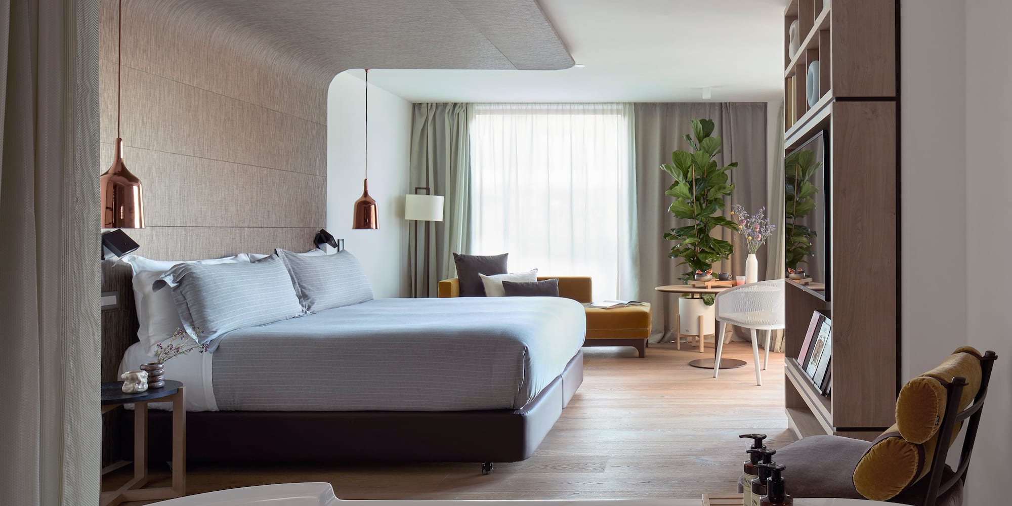 a bedroom with a bed and a tv