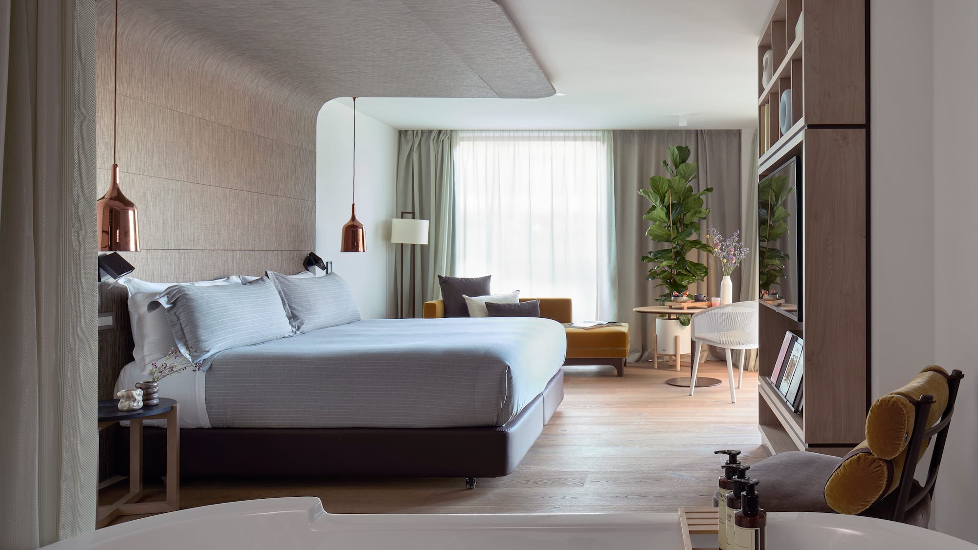 a bedroom with a bed and a tv