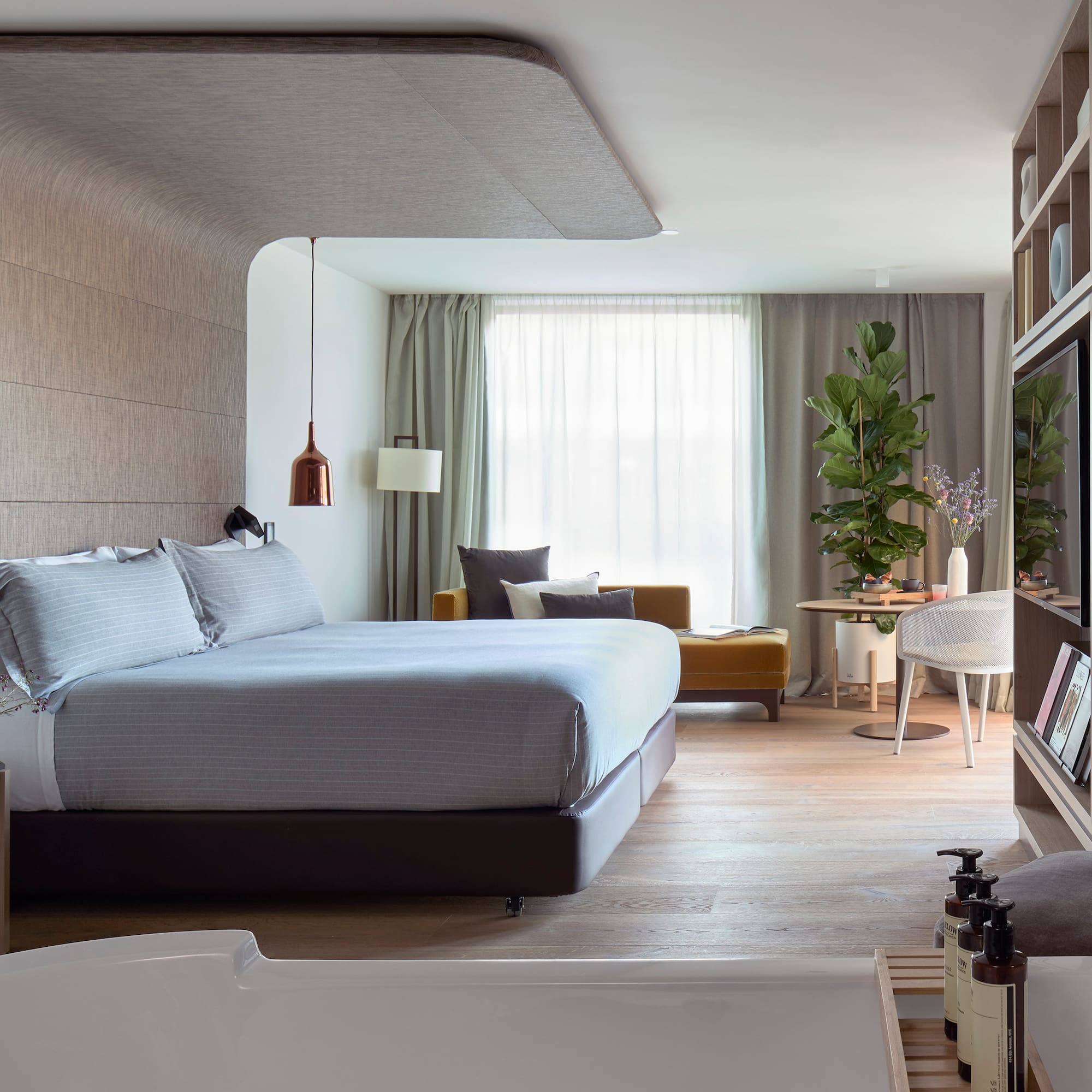 a bedroom with a bed and a tv