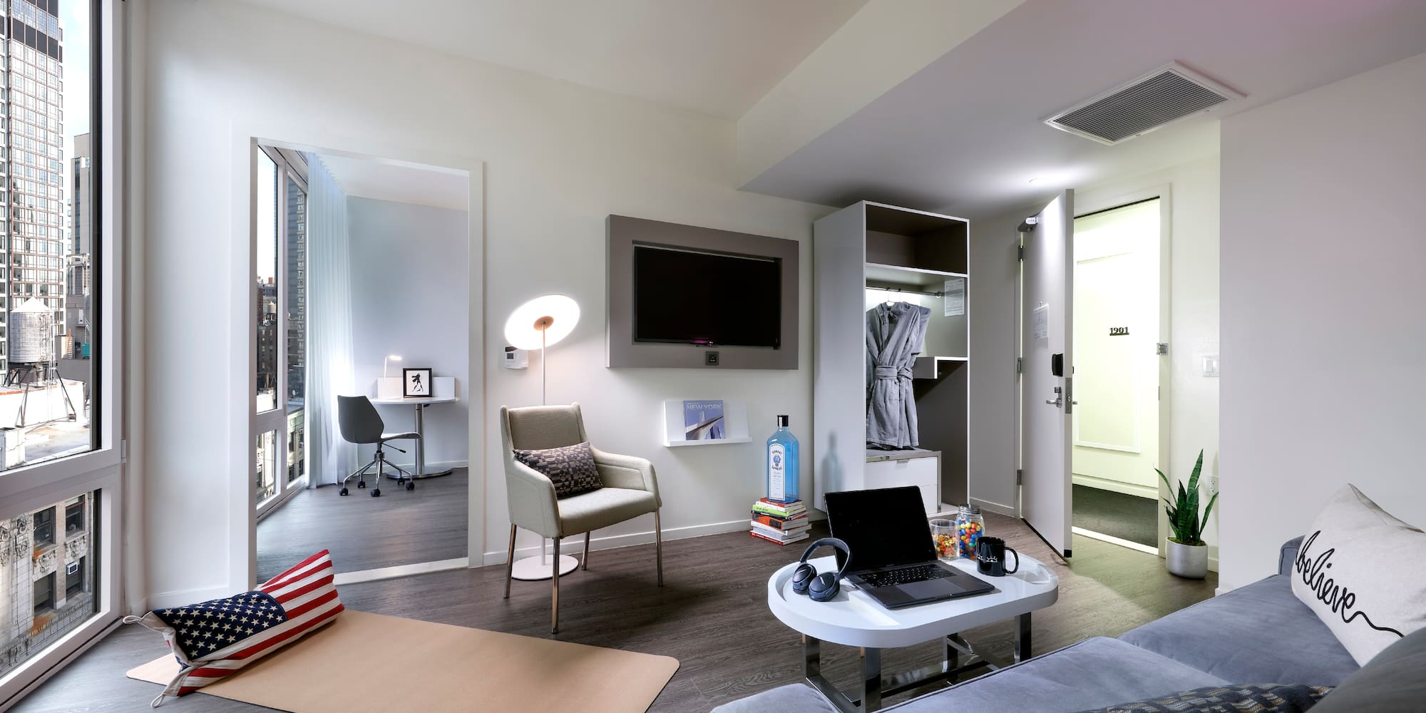 a room with a laptop and a tv