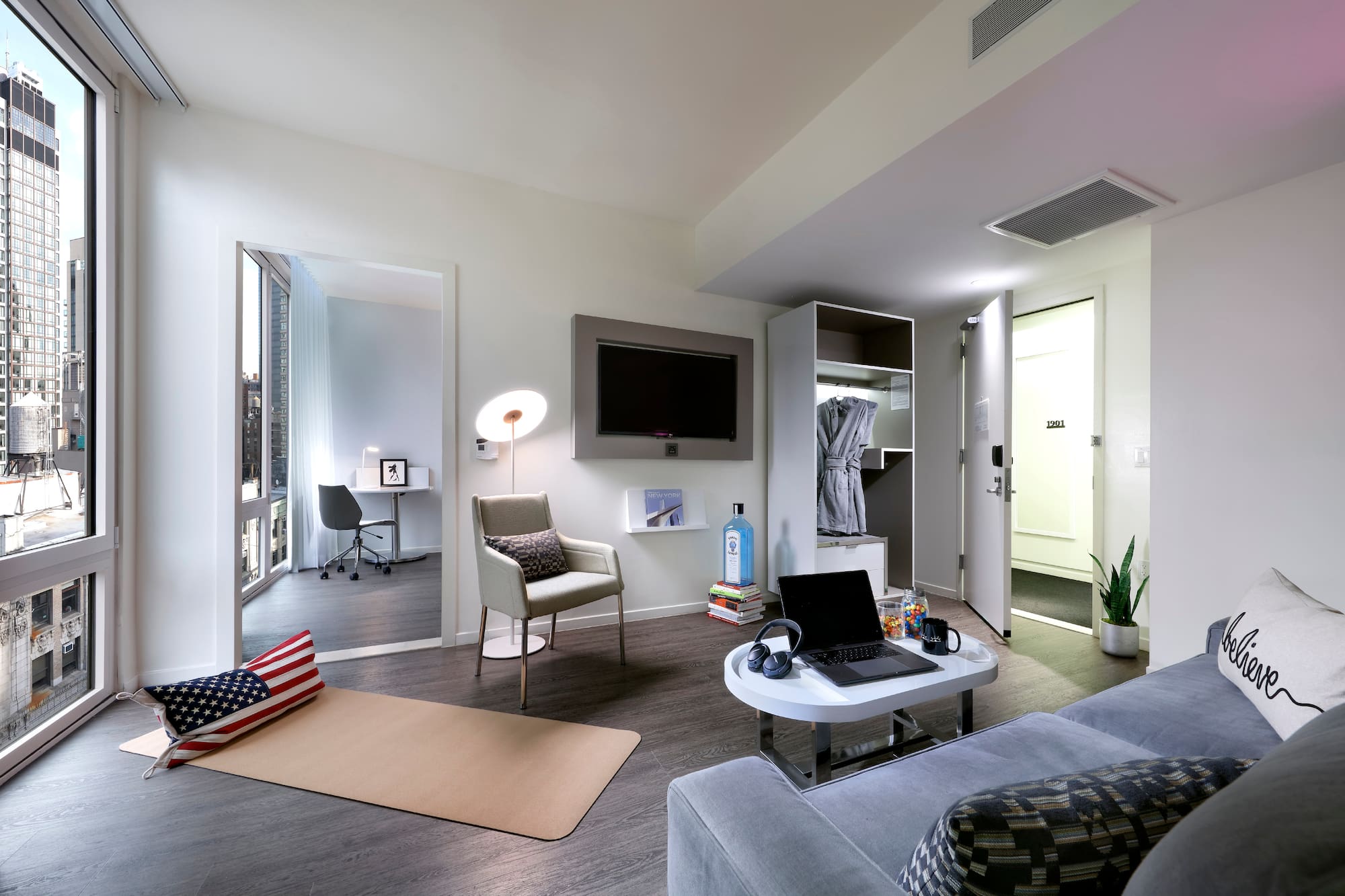 a room with a laptop and a tv