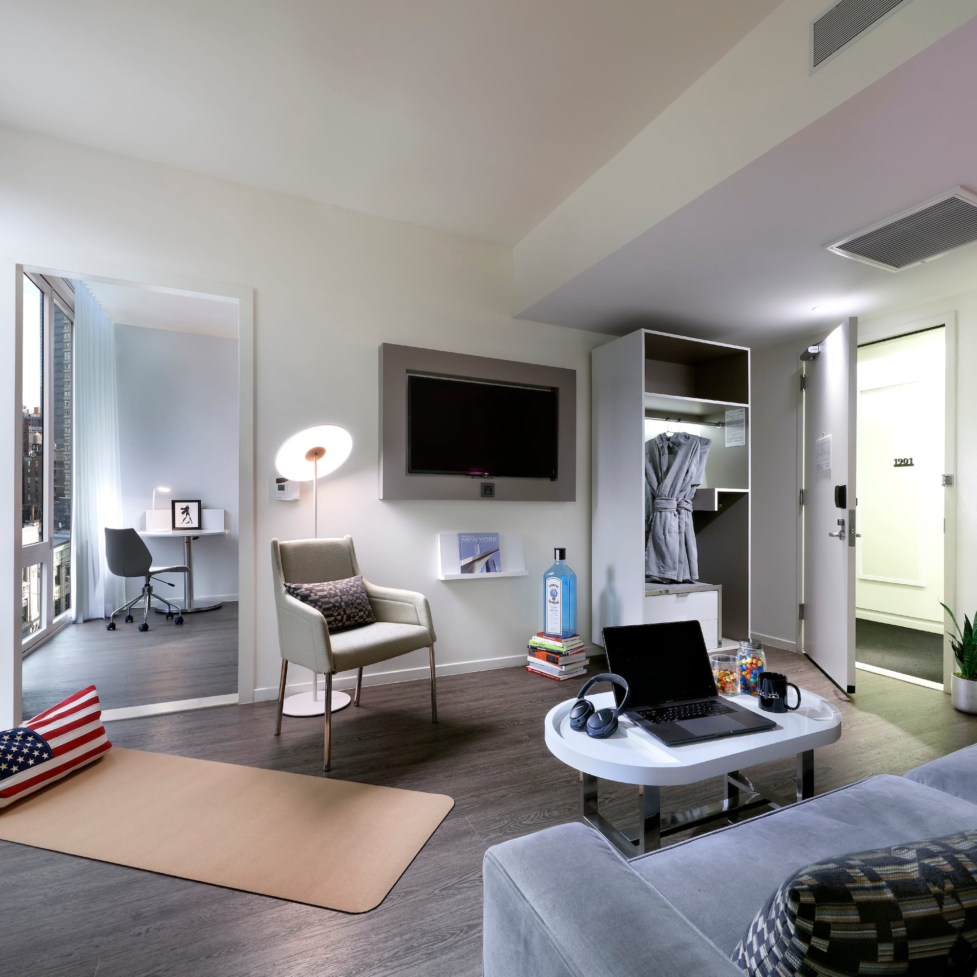 a room with a laptop and a tv