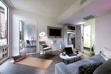 a room with a laptop and a tv