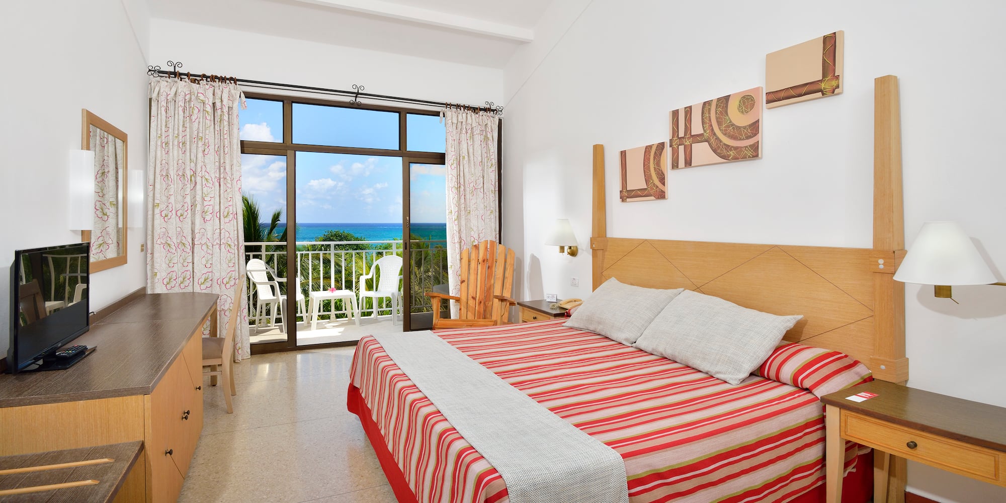 a bedroom with a large window overlooking the ocean