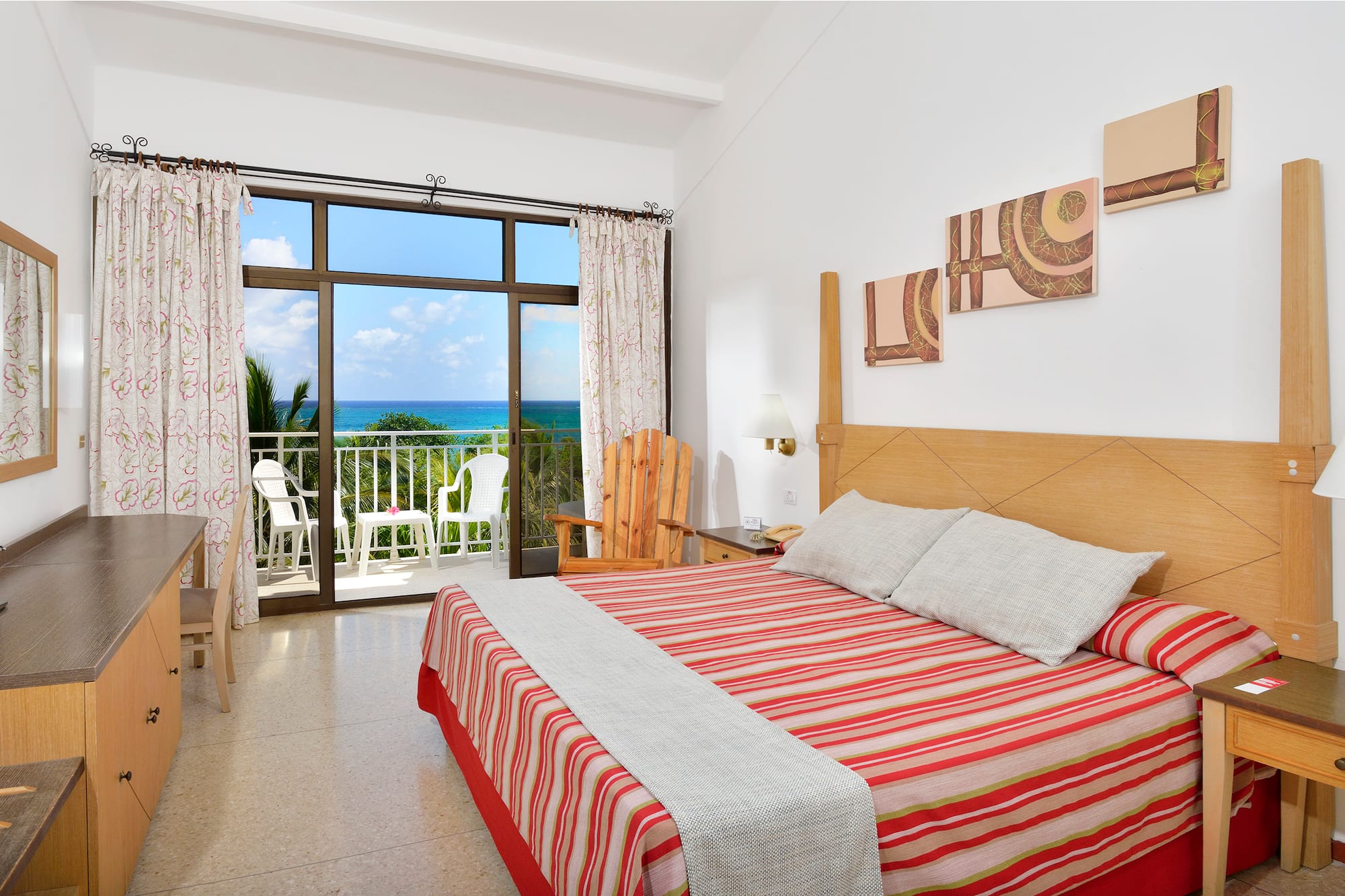 a bedroom with a large window overlooking the ocean