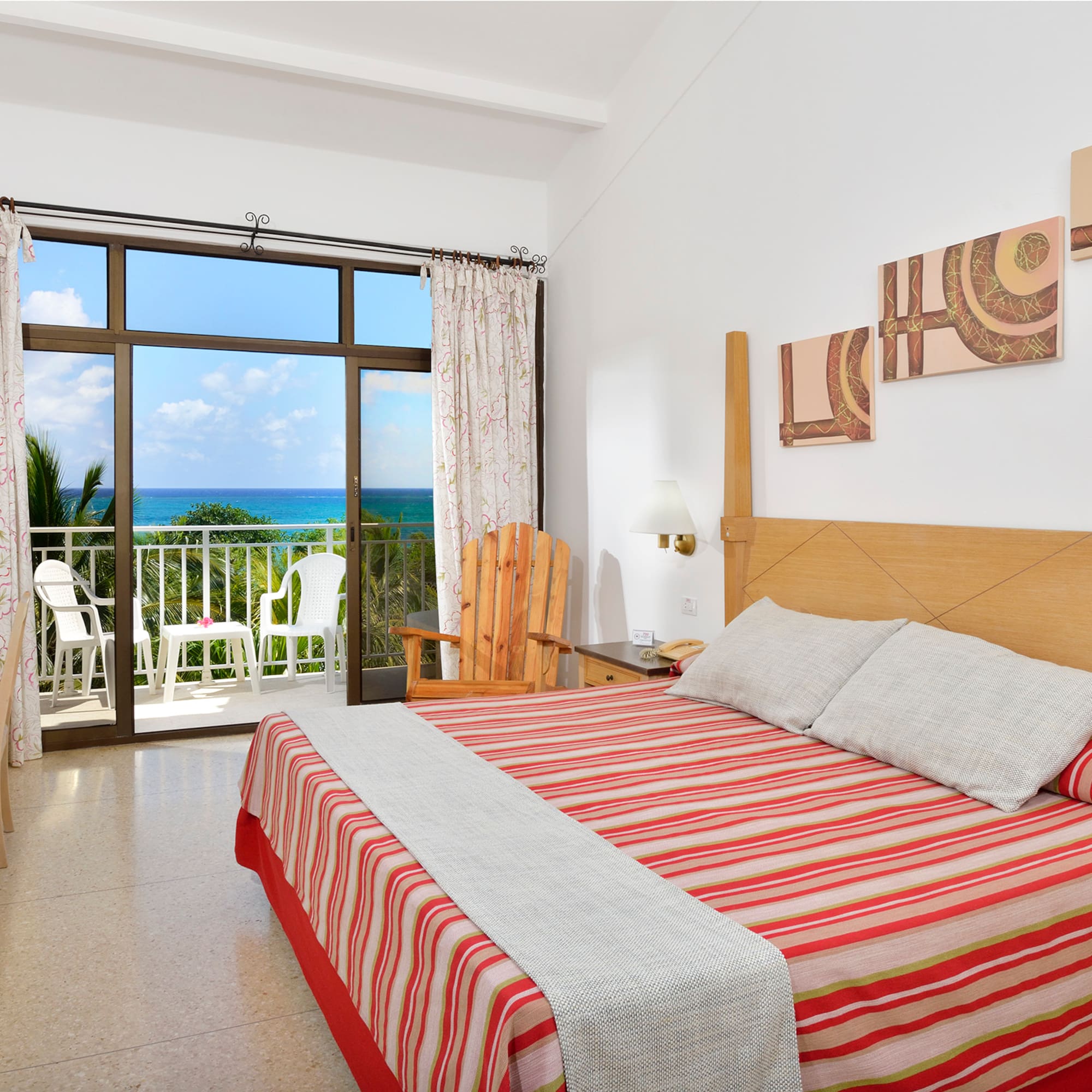 a bedroom with a large window overlooking the ocean