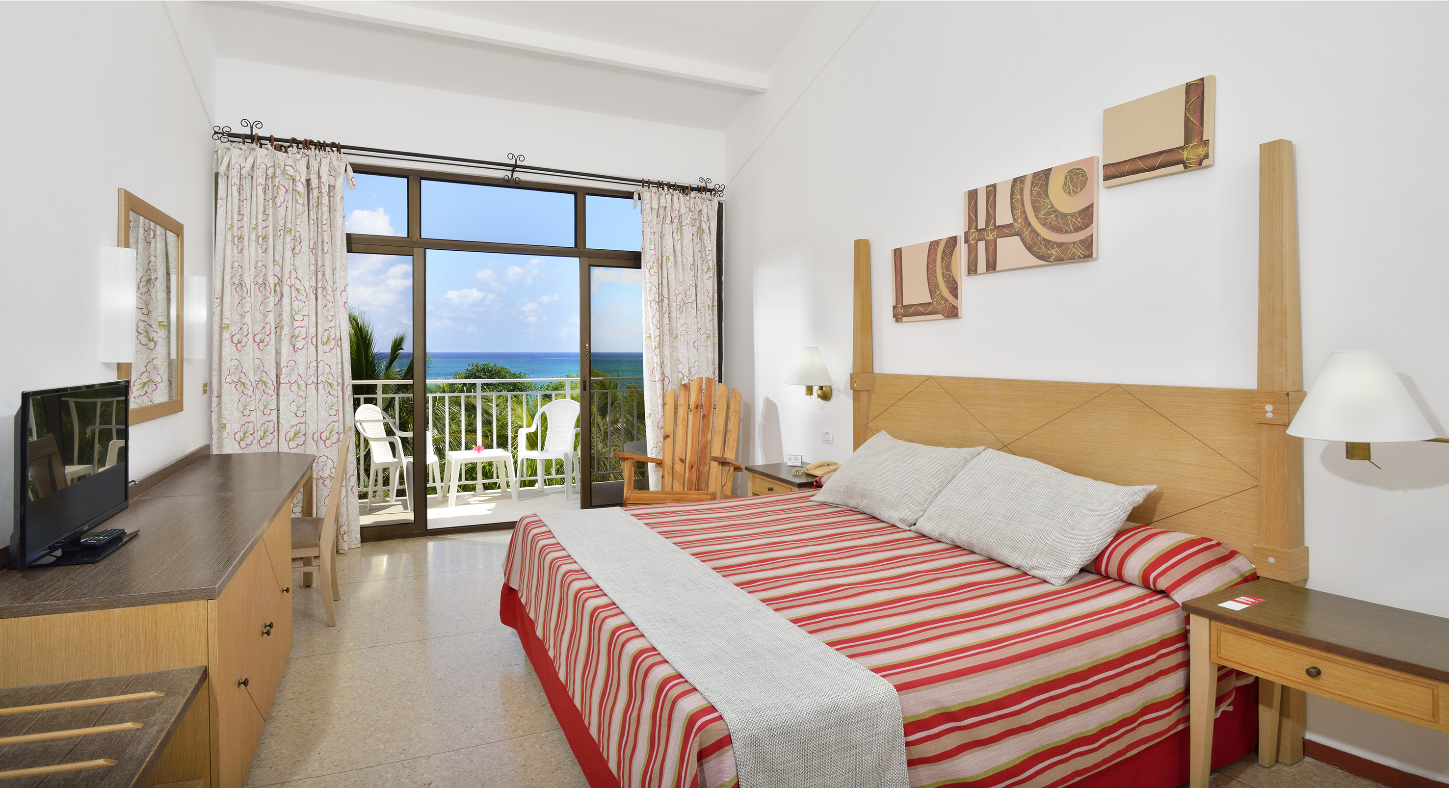a bedroom with a large window overlooking the ocean