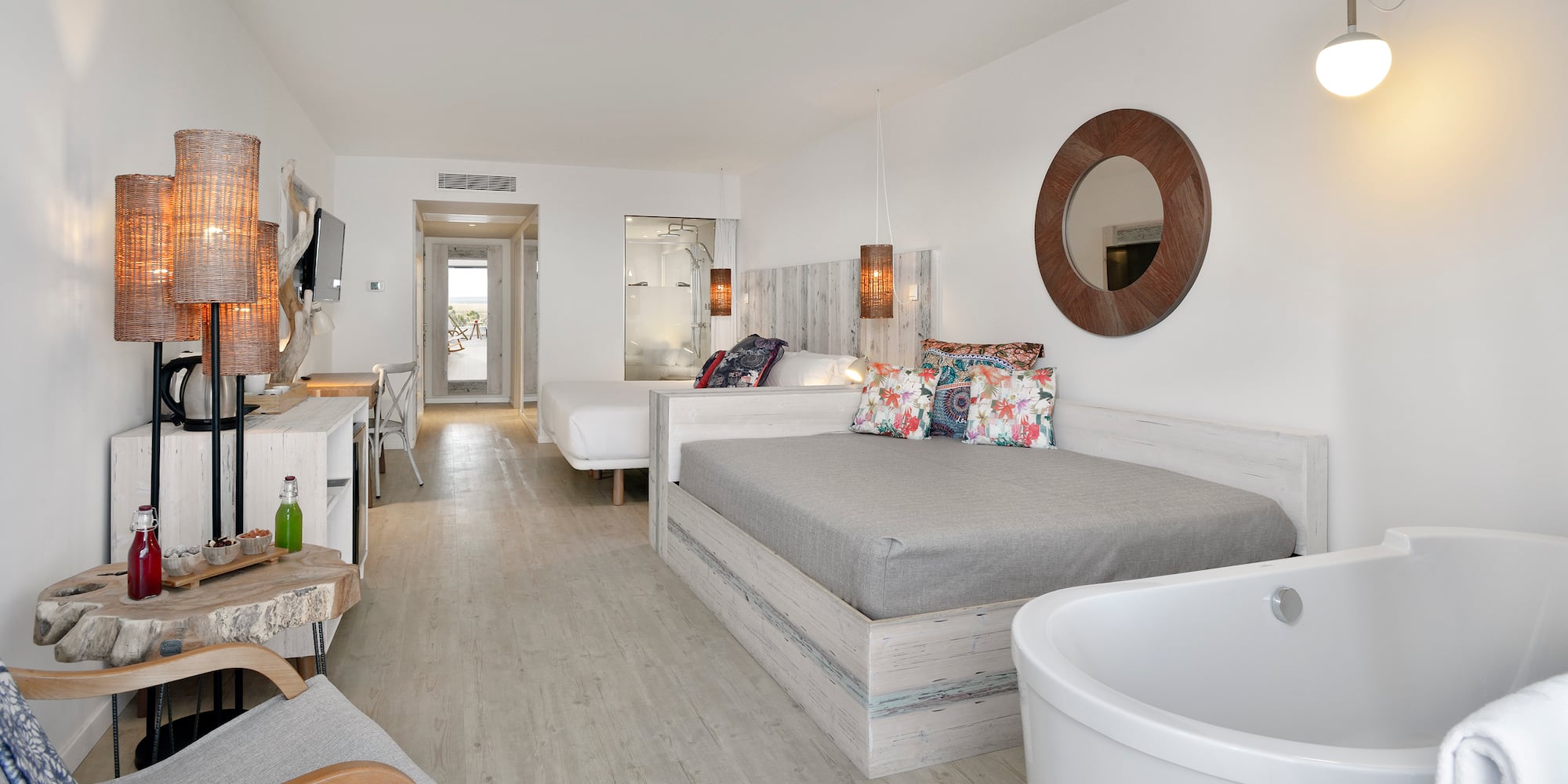 a room with two beds and a tub