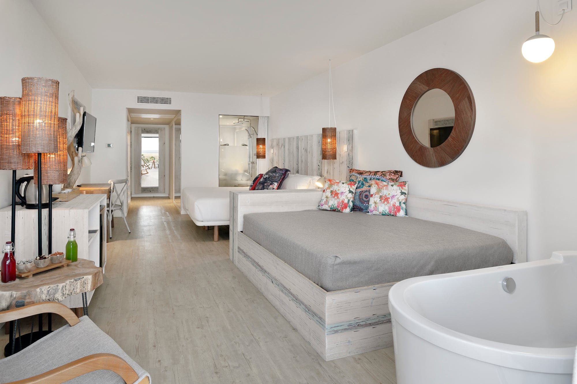 a room with two beds and a tub