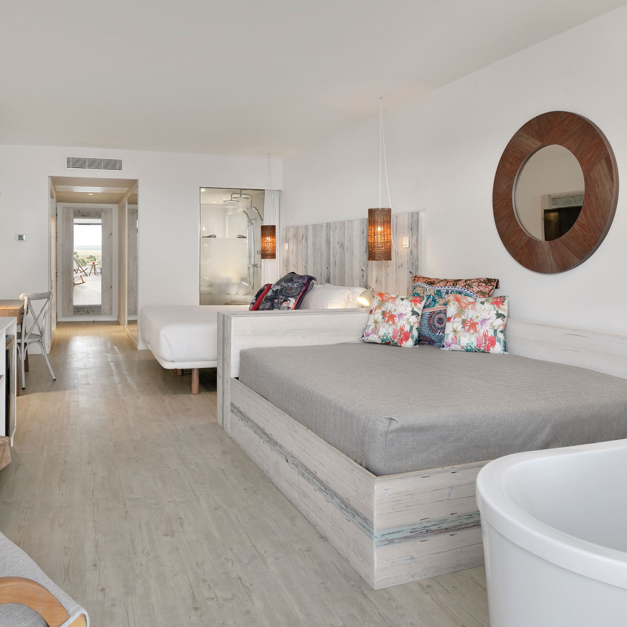 a room with two beds and a tub