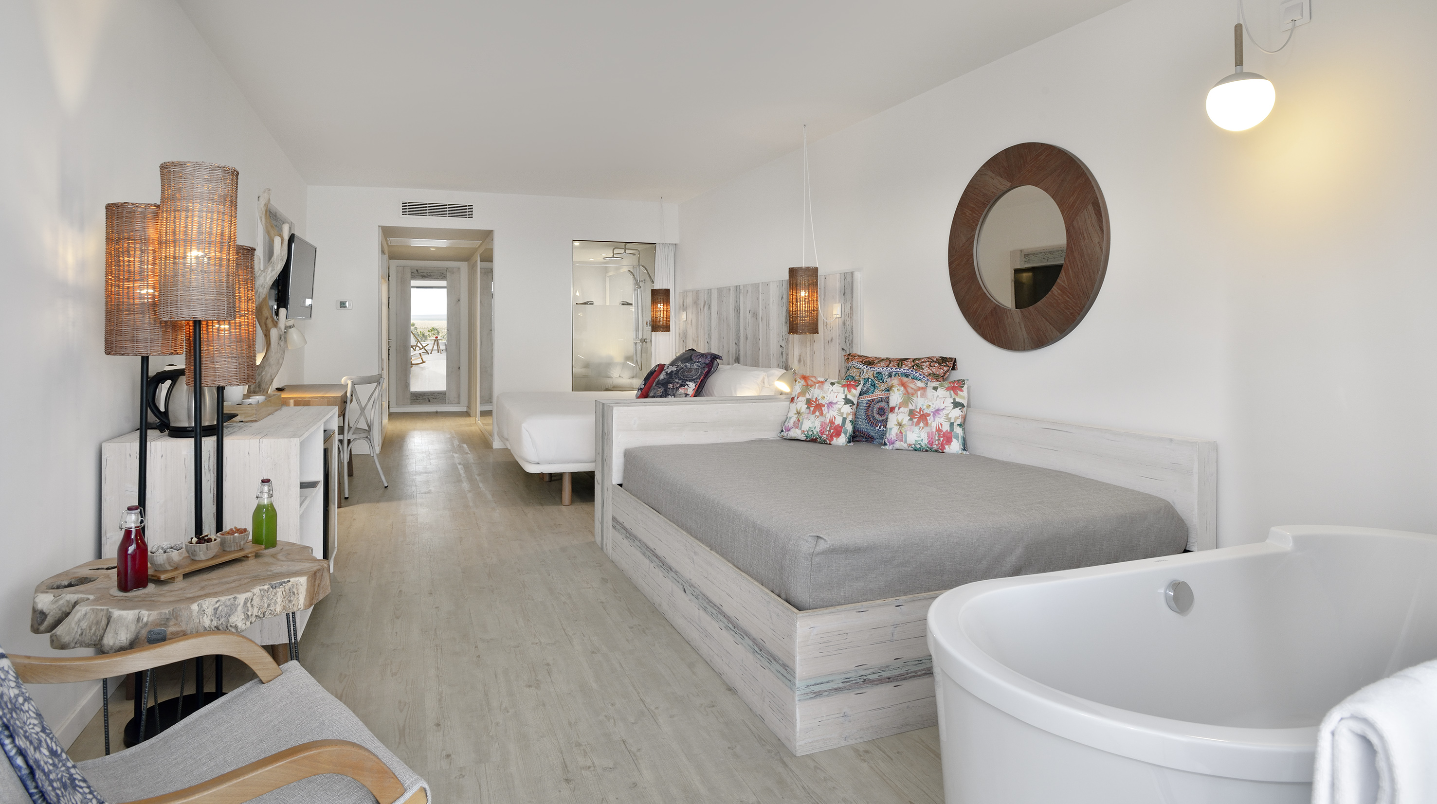 a room with two beds and a tub