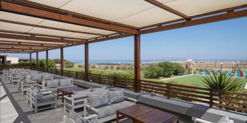 a patio with chairs and tables
