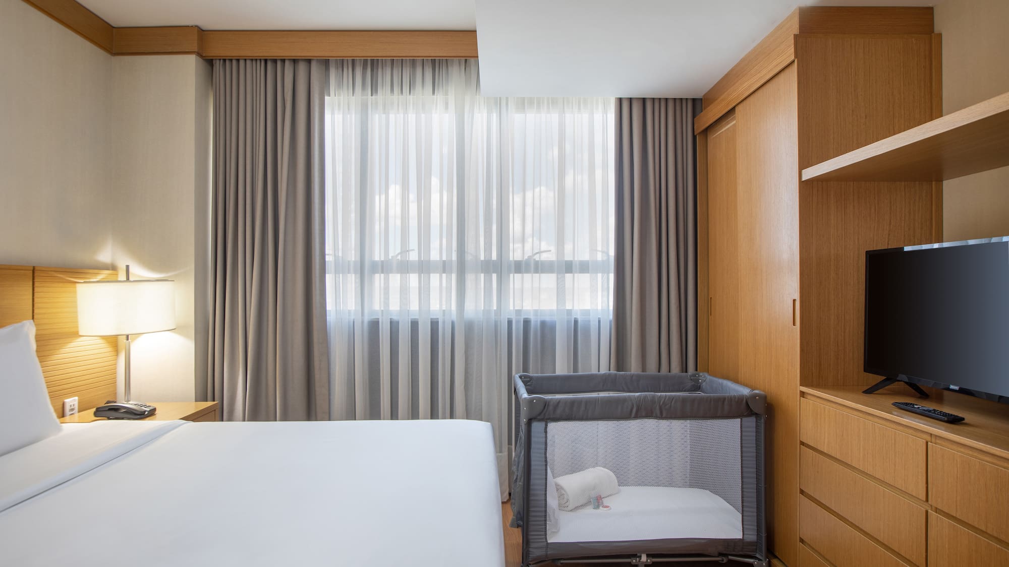 a room with a bed and a crib