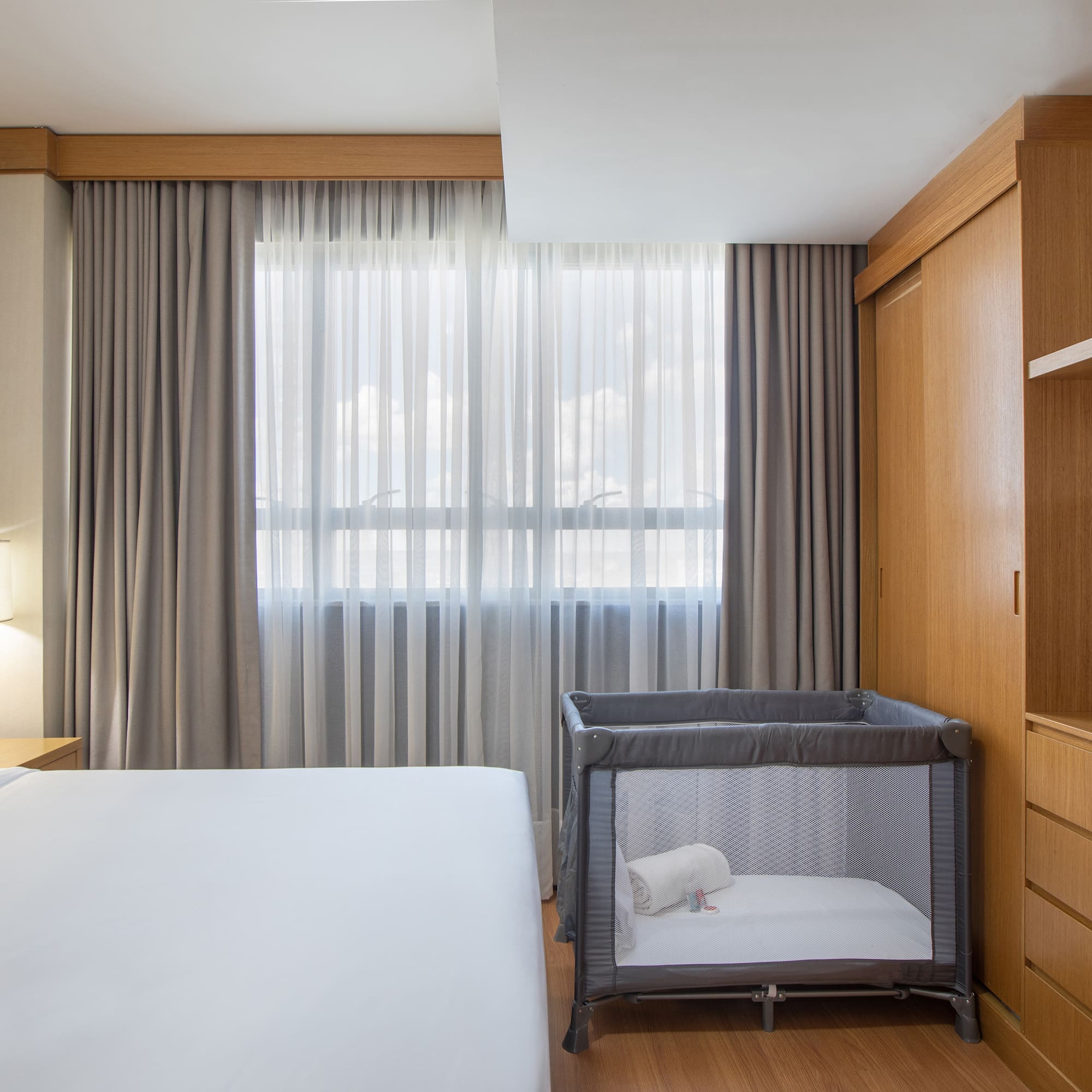 a room with a bed and a crib