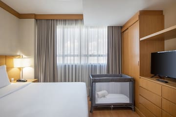 a room with a bed and a crib