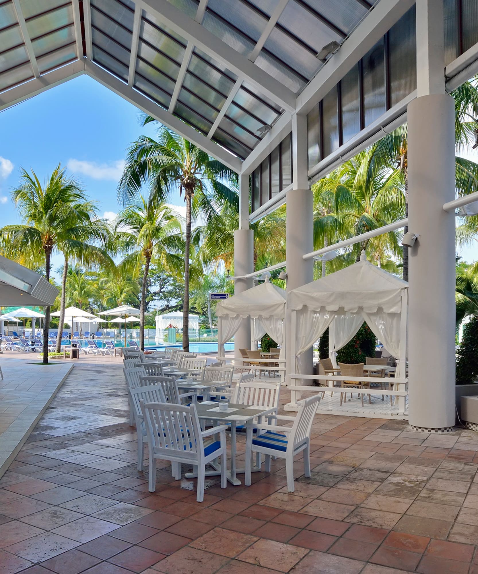 a patio with tables and chairs and umbrellas