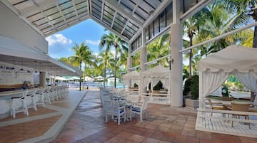 a patio with tables and chairs and umbrellas