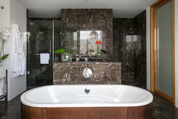 a bathroom with a tub and shower
