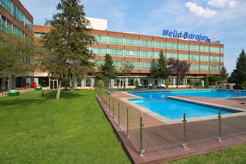 a building with a pool and grass