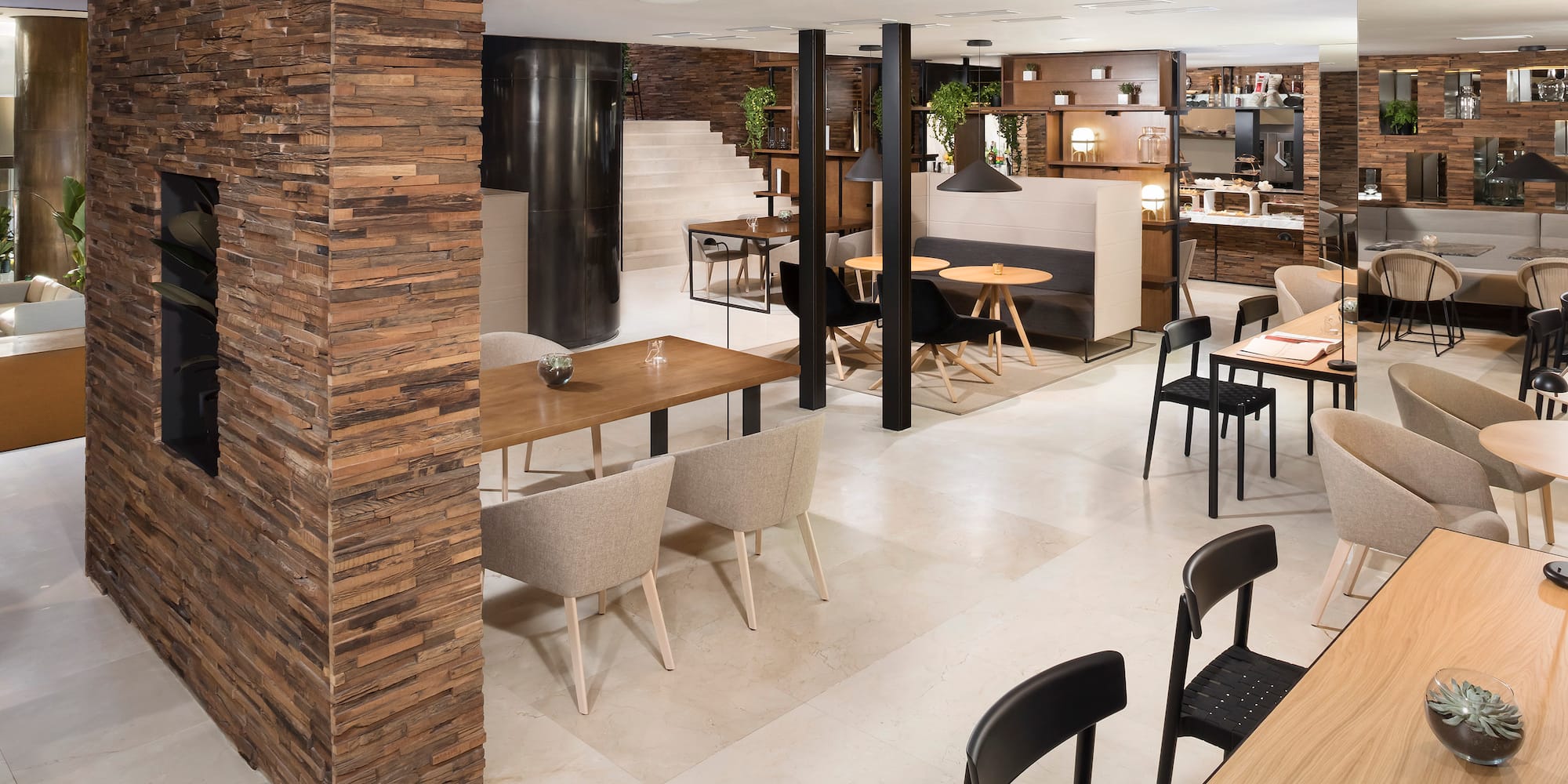 a room with a large column and a table and chairs