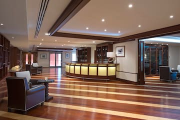 a room with a reception desk and chairs