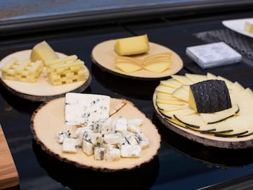 a group of wooden plates with different types of cheese