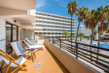 a deck with chairs and palm trees