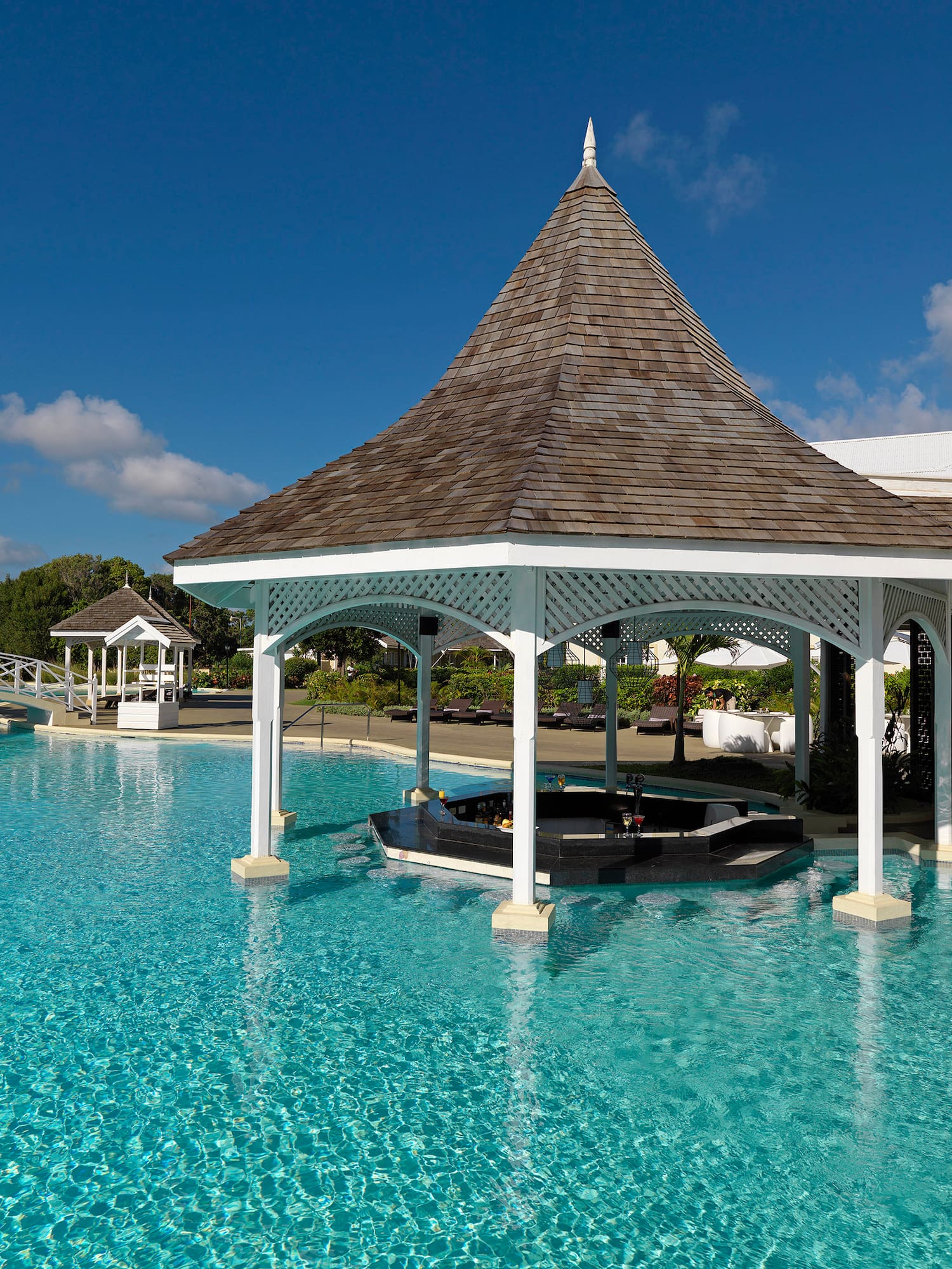 a pool with a gazebo and a gazebo