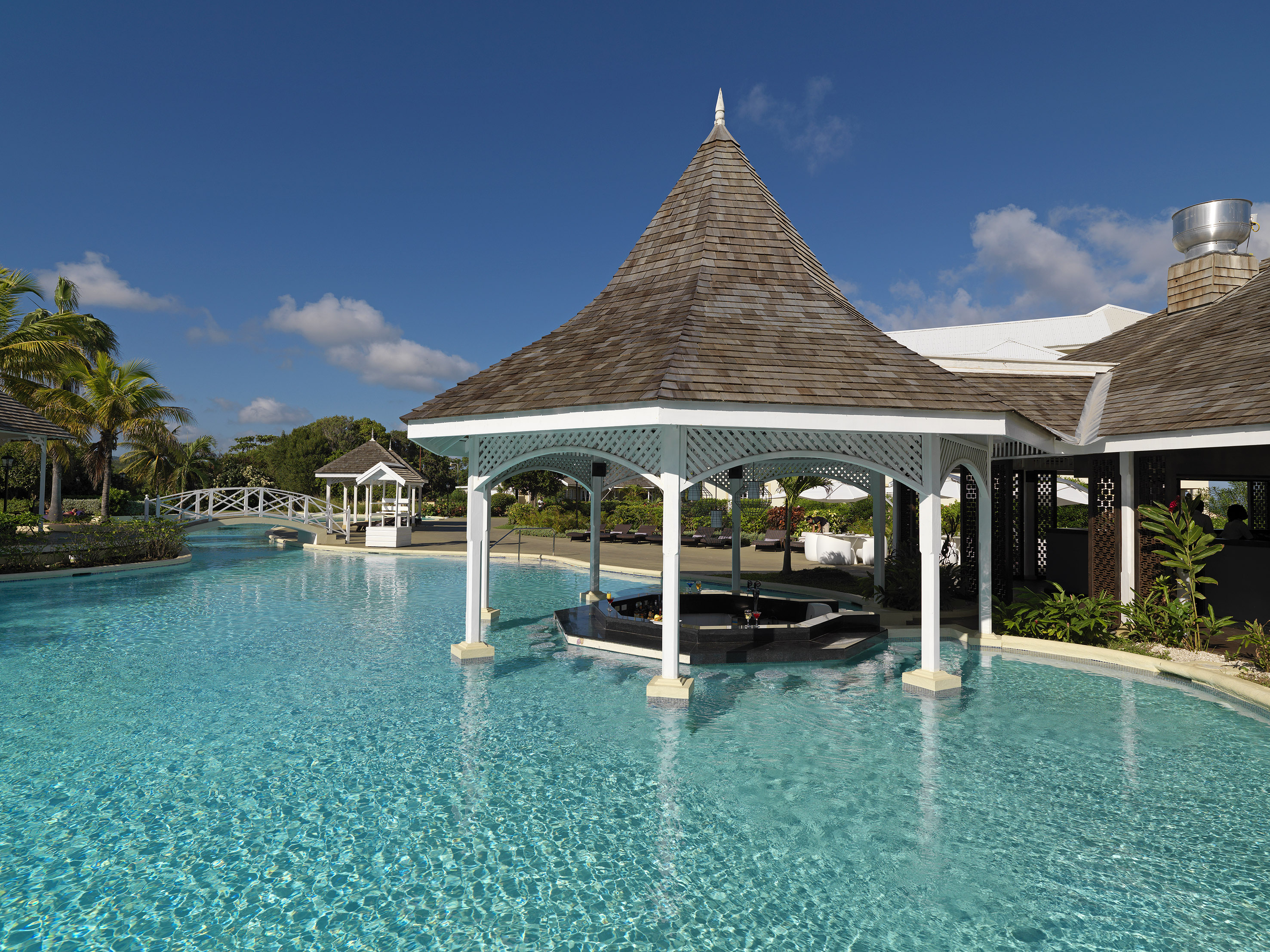 a pool with a gazebo and a gazebo