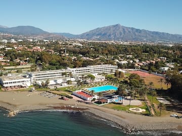a beach with a swimming pool and a large building