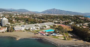 a beach with a swimming pool and a large building