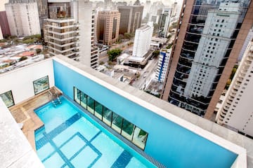 a rooftop pool with a city in the background