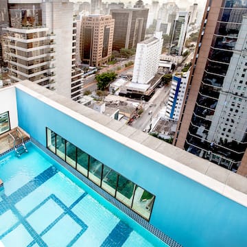 a rooftop pool with a city in the background