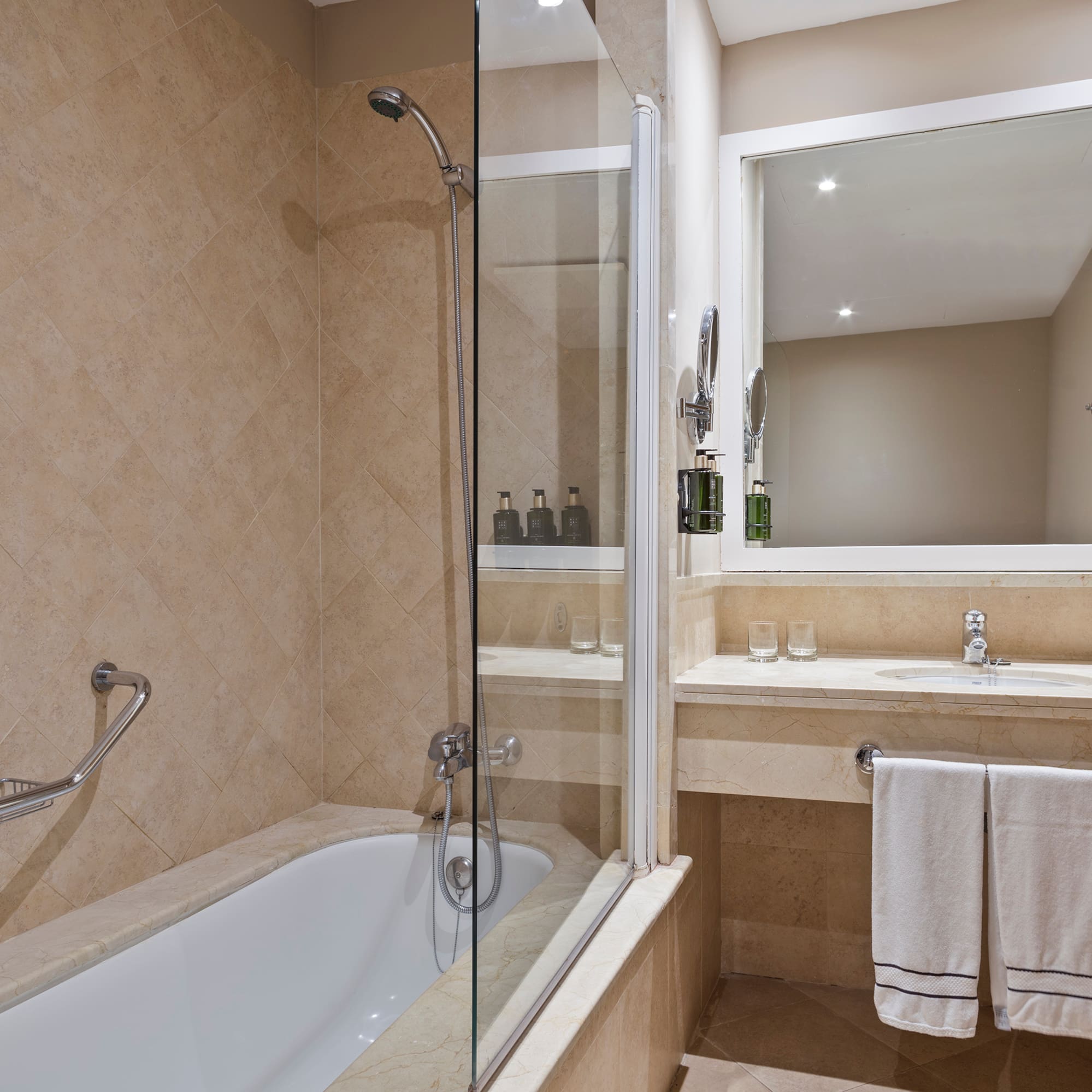 a bathroom with a glass shower and bathtub