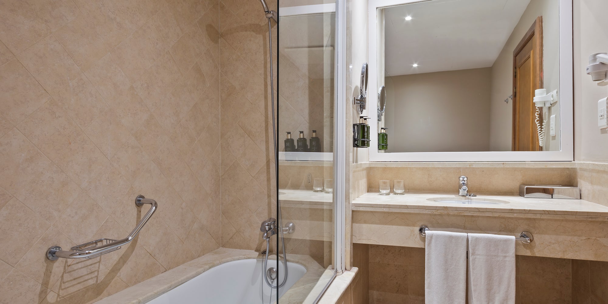 a bathroom with a glass shower and bathtub