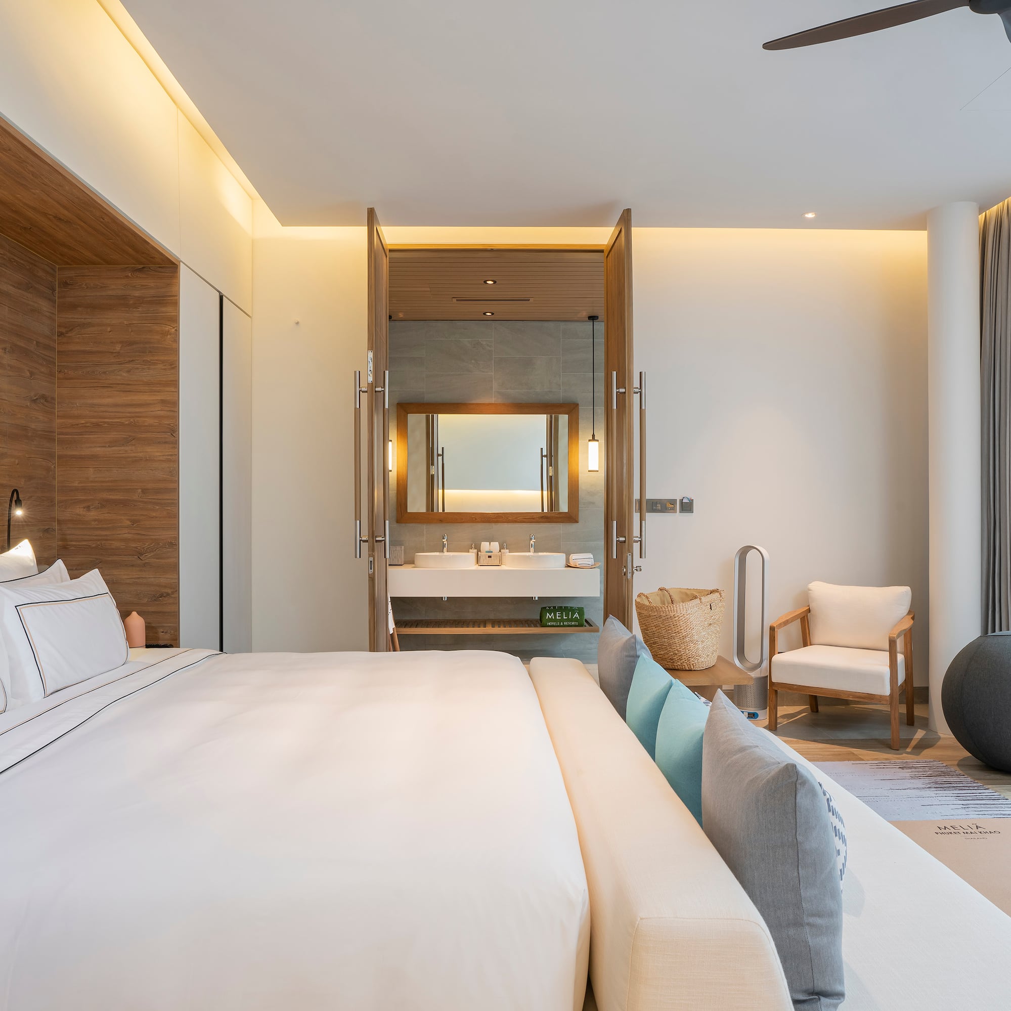 a bedroom with a large bed and a sink