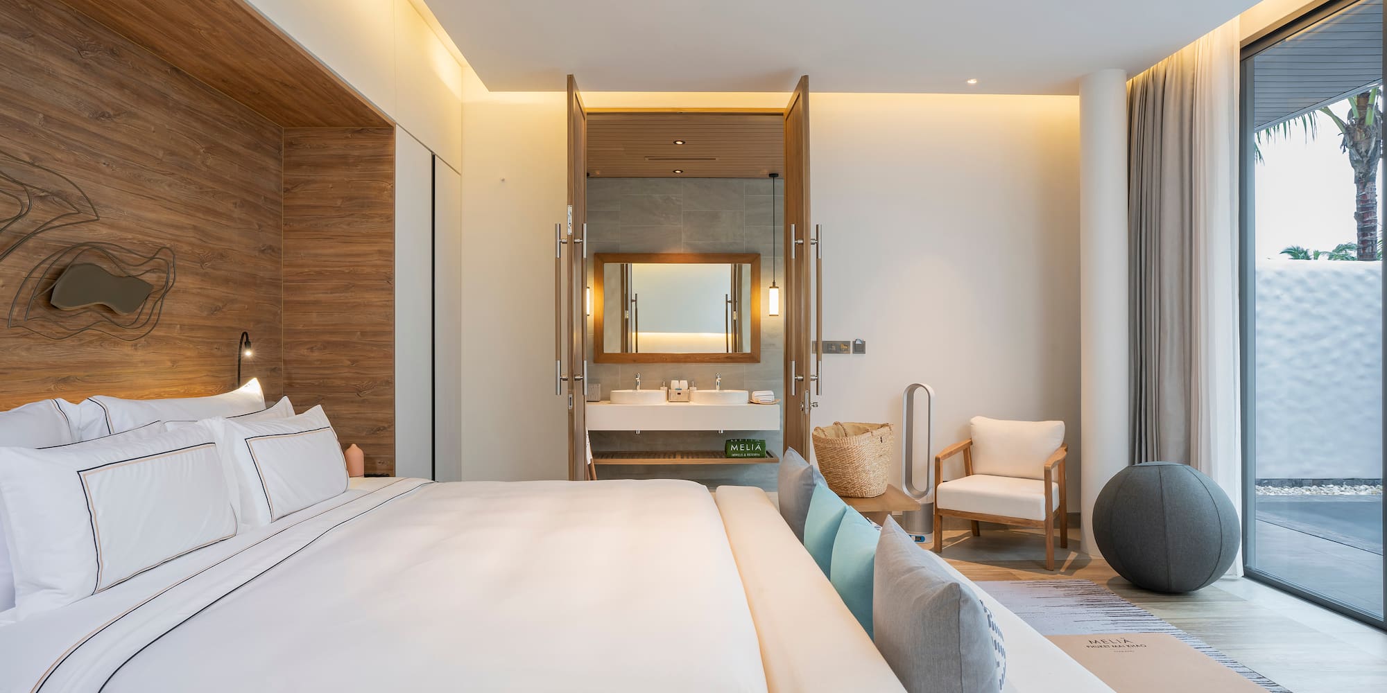 a bedroom with a large bed and a sink