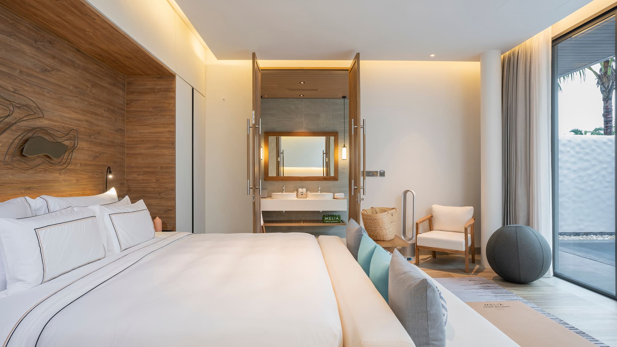 a bedroom with a large bed and a sink