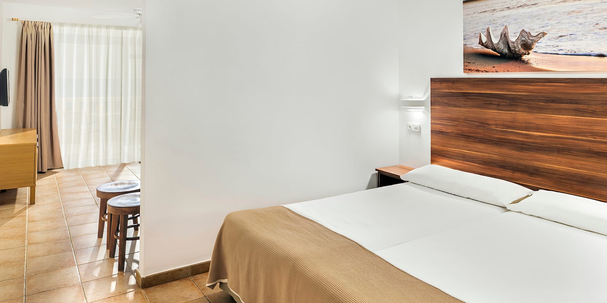 a bedroom with a bed and a picture on the wall