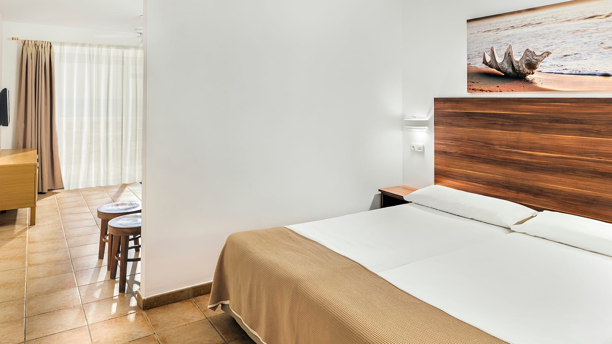 a bedroom with a bed and a picture on the wall