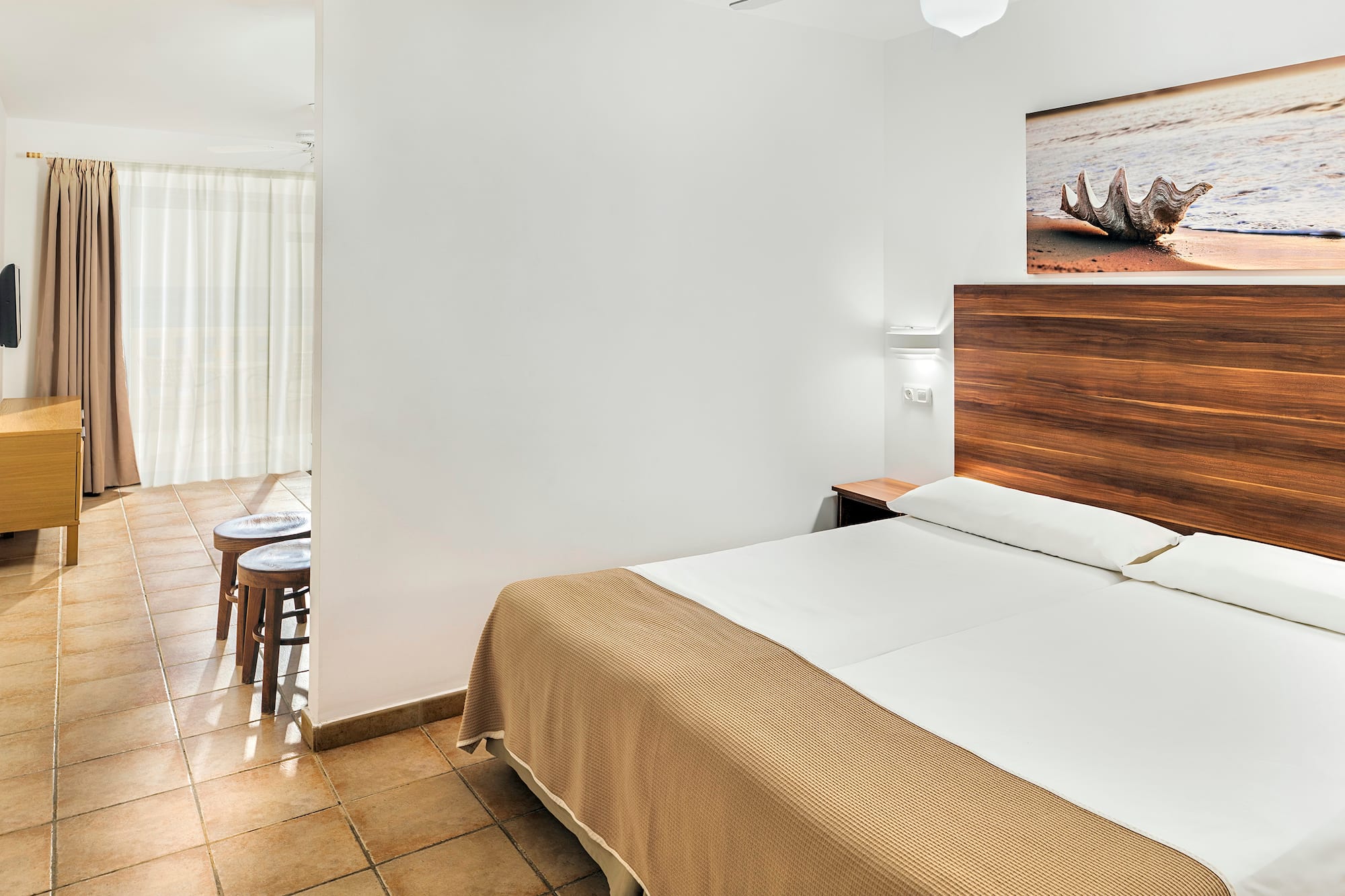 a bedroom with a bed and a picture on the wall