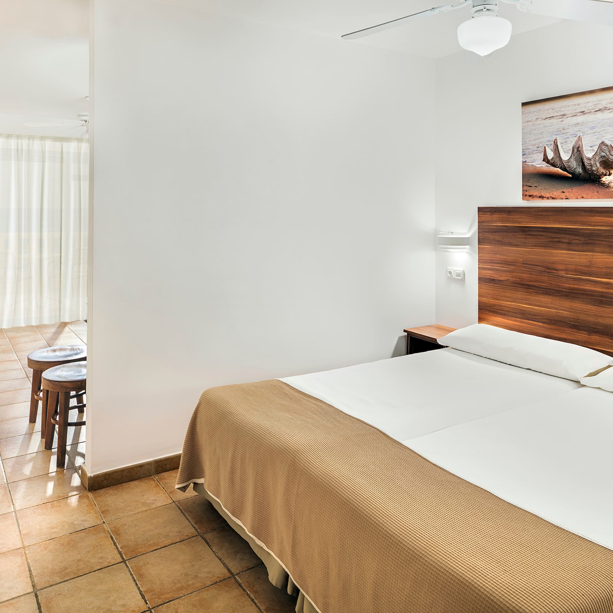 a bedroom with a bed and a picture on the wall