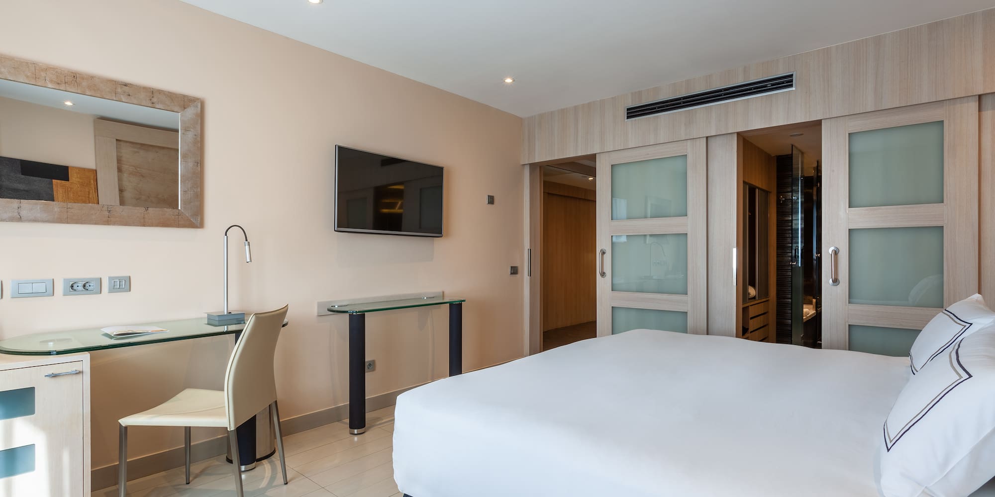 a bedroom with a bed and a desk