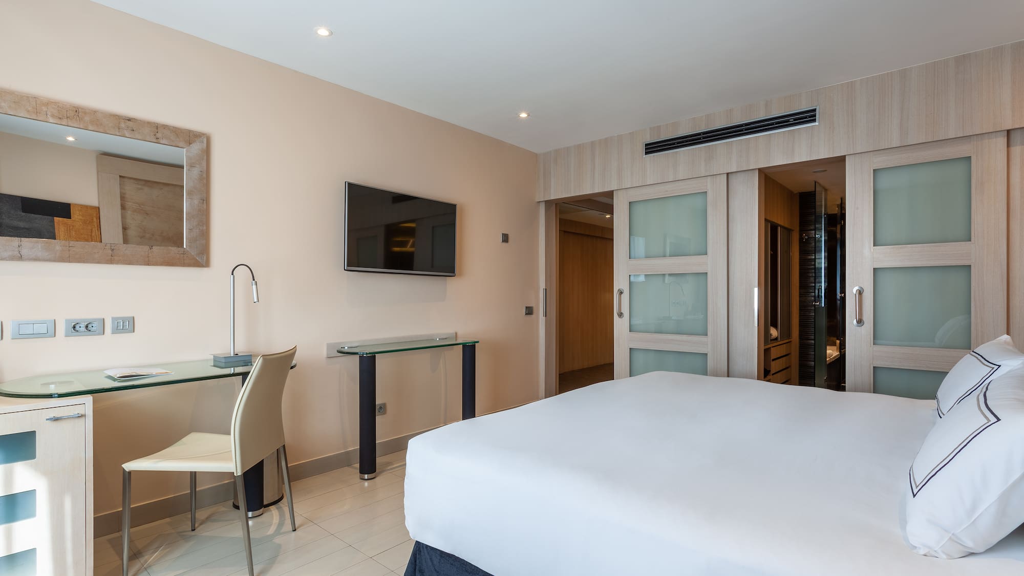 a bedroom with a bed and a desk